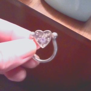 Silver swinging heart ring says yes on one side and no on the other side